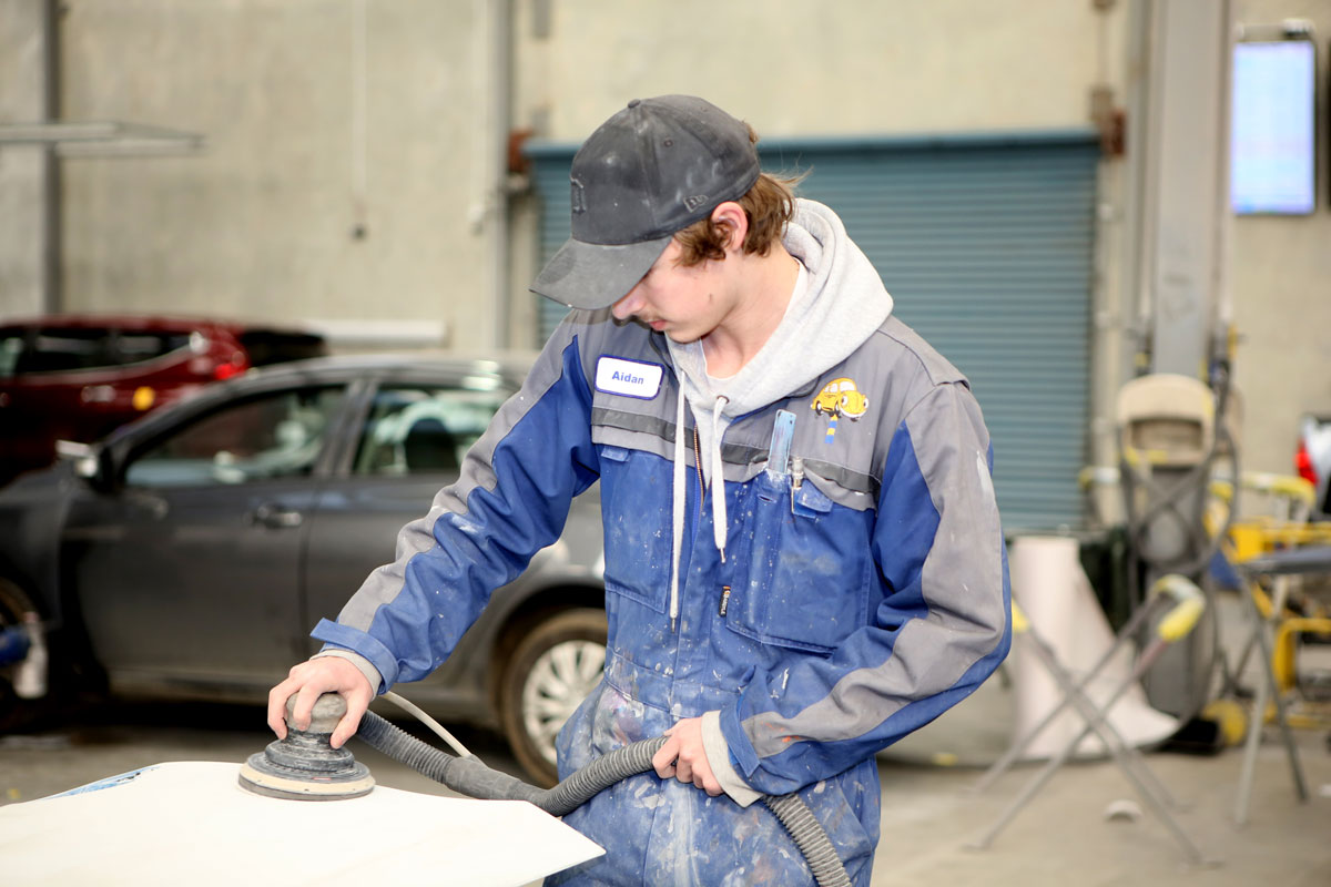 Boy Using Sander